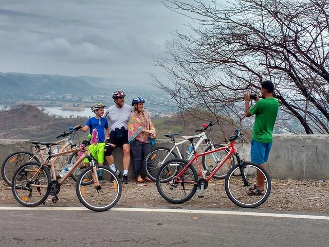 A family posing for a photo with their bicycles during a tour.