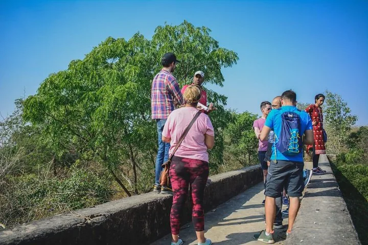 Tourists standing on a wall listening to their guide at Nahargarh Fort.