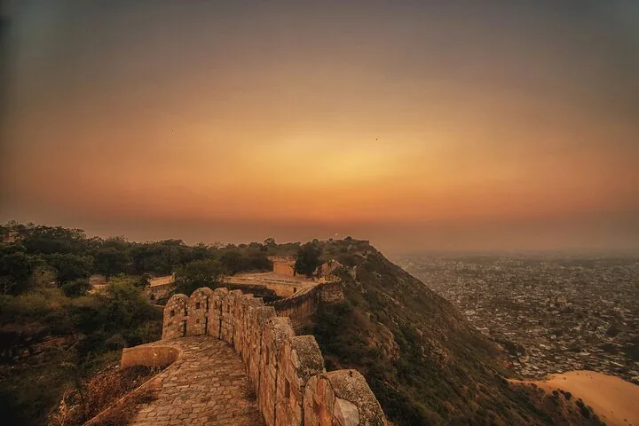 A scenic sunset view over the city from Nahargarh Fort walls.